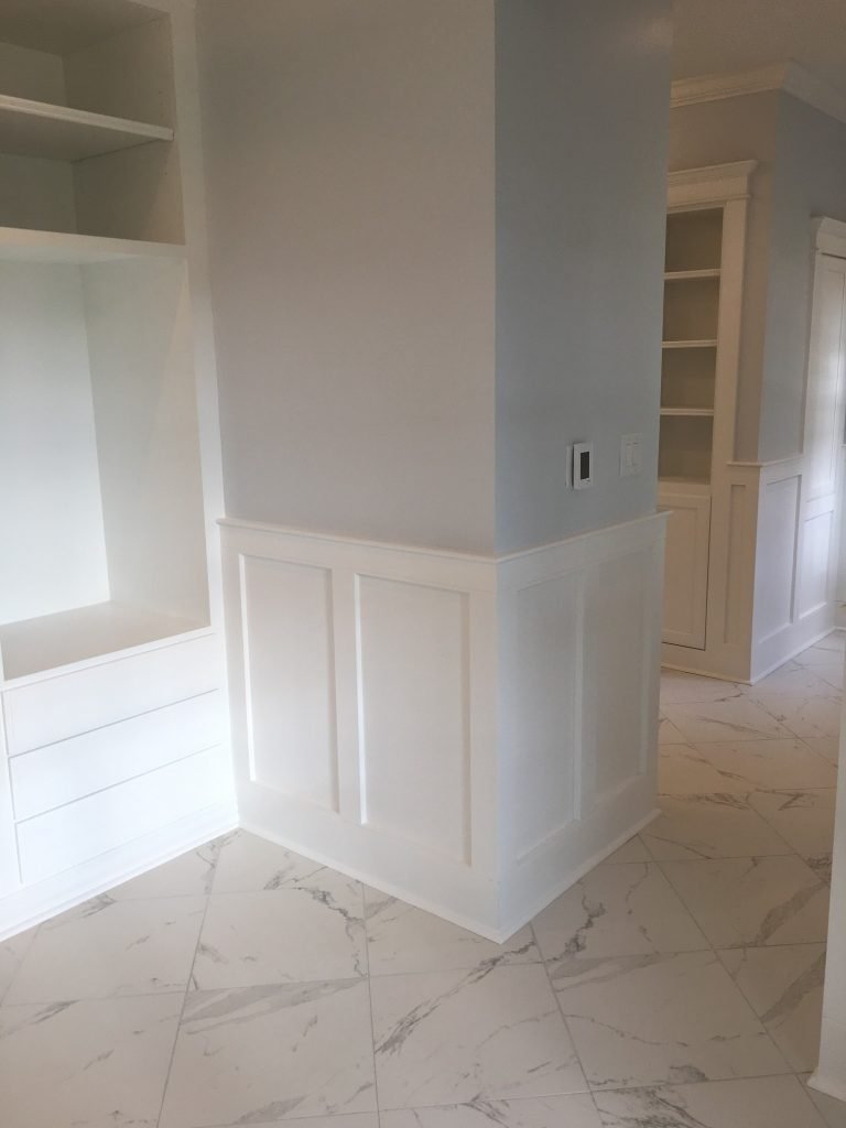 Elegant Storage Solutions Featuring Wainscoting and Built-In Cabinetry