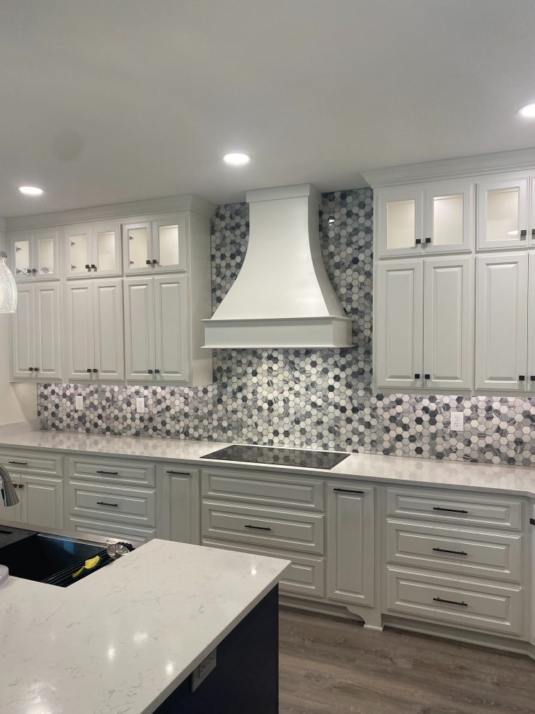 Custom Kitchen Wall with Statement Range Hood, Full-Height Cabinetry, and Mosaic Backsplash