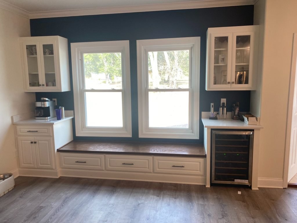 Custom Window Bench Wall with Glass-Front Cabinets and Built-In Beverage Center