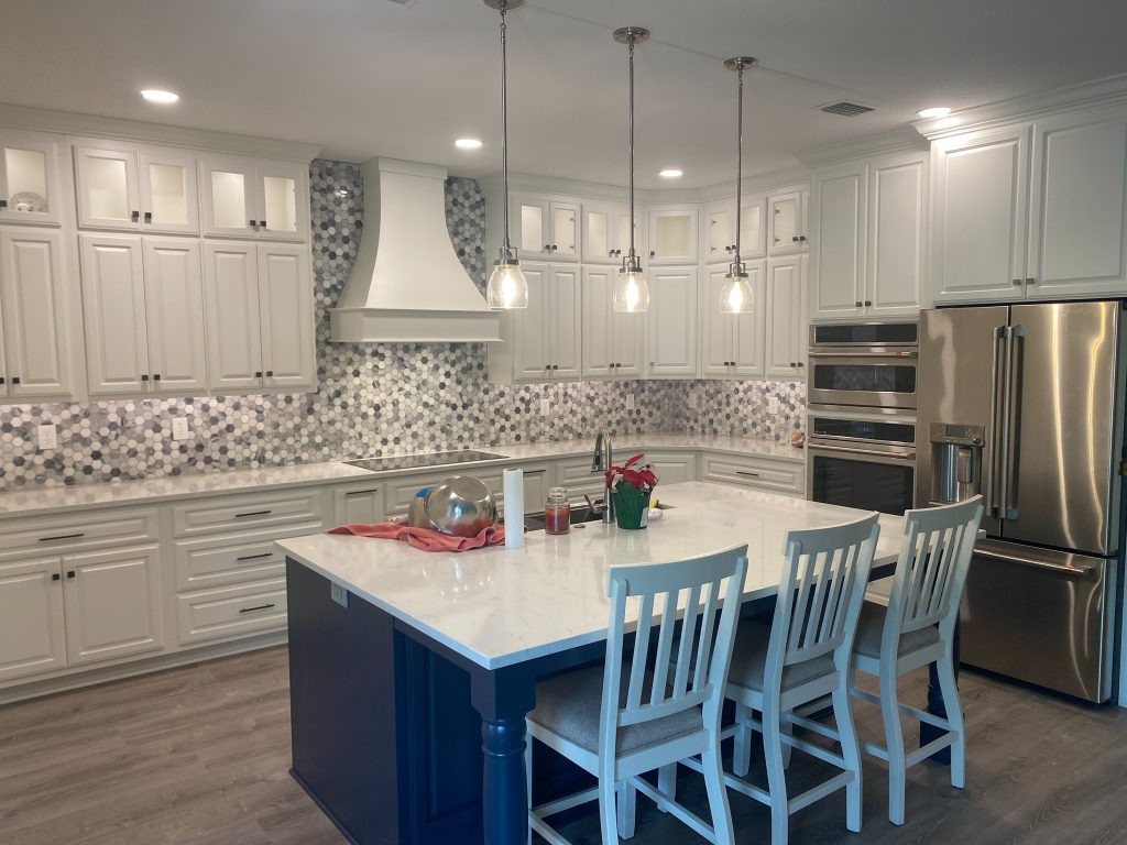 Premium Kitchen Focal Wall with Statement Hood Surround, Mixed Cabinetry Styles, and Decorative Backsplash