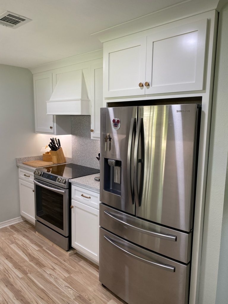 Sleek Kitchen Design with Built-In Hood and Polished Stainless Steel Finish