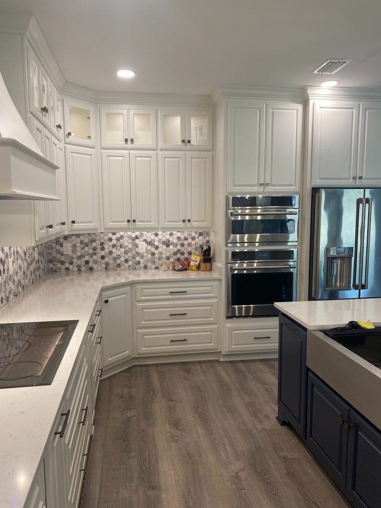 Modern Classic Cabinetry Wall with Integrated Vent Hood, Ample Storage, and Quartz Countertops