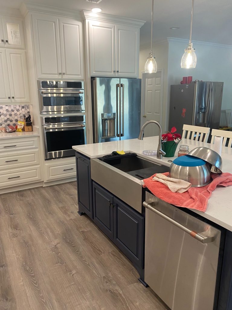 Luxury Kitchen Built-Ins Featuring Detailed Cabinetry, Curved Hood Design, and Hex Tile Backsplash