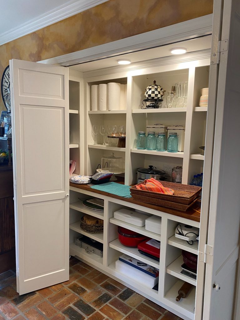 Built-In Cabinet System Featuring Adjustable Shelving, Counter Work Area, and Lower Cubbies
