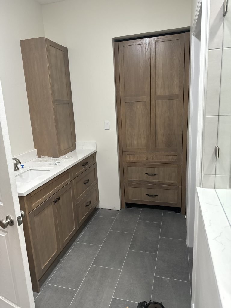 Modern Light Wood Bathroom Vanity with Tall Linen Cabinet and Gray Tile Floor