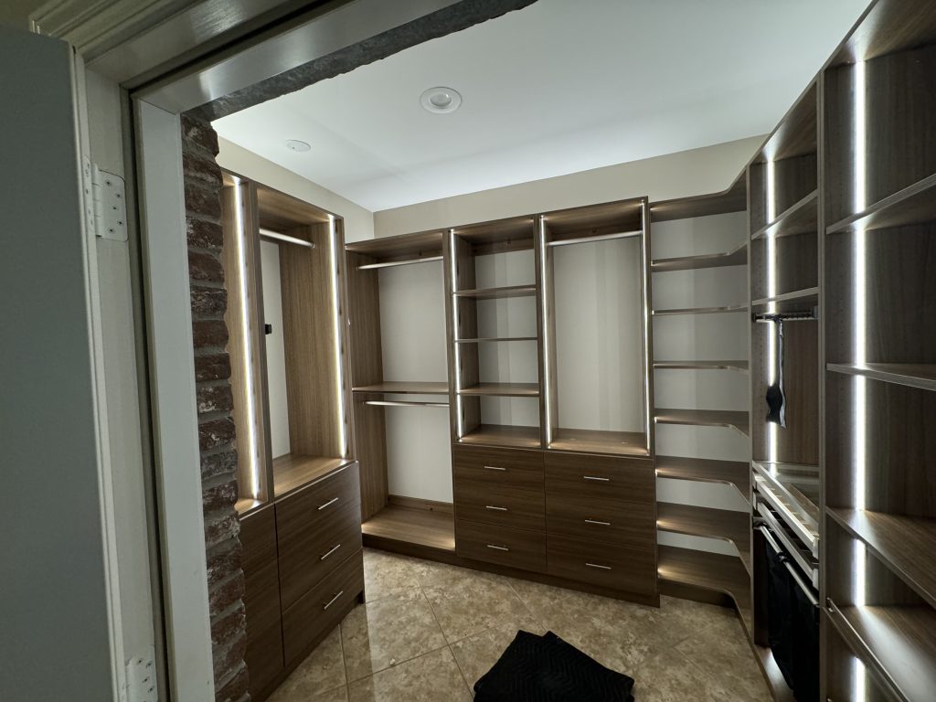 Elegant Closet Organization with Wood Shelving and Chrome Accents