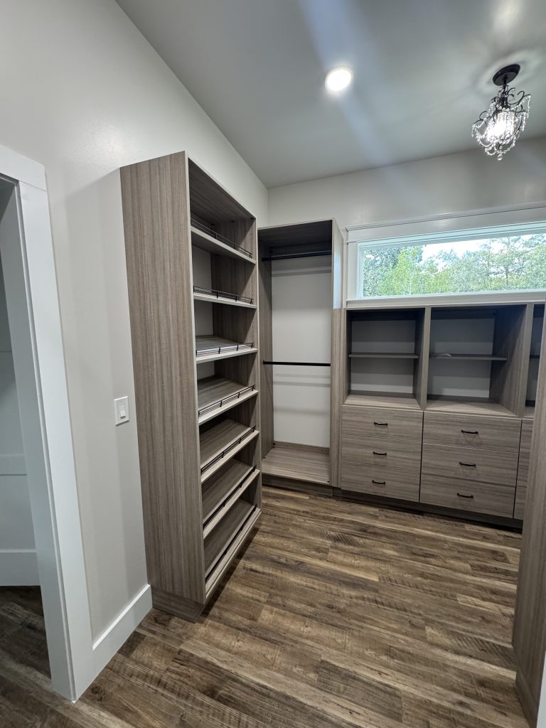 Spacious Walk-In Closet with Built-In Shelving and Storage Cabinets